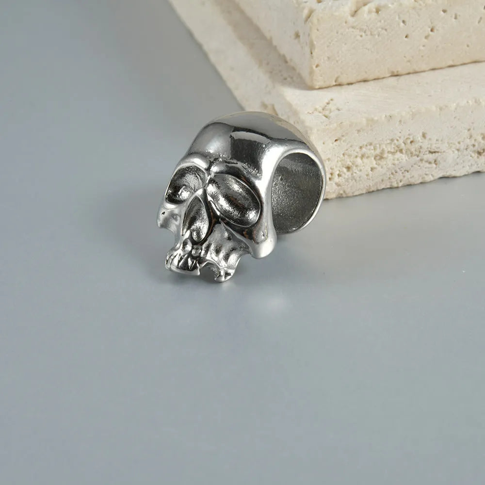 Stainless steel hollow skull Buddha earrings in hip hop style, showing geometry design.
