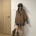 Women's plush triangle shawl cape with long tassels, shown in a choice of colours.