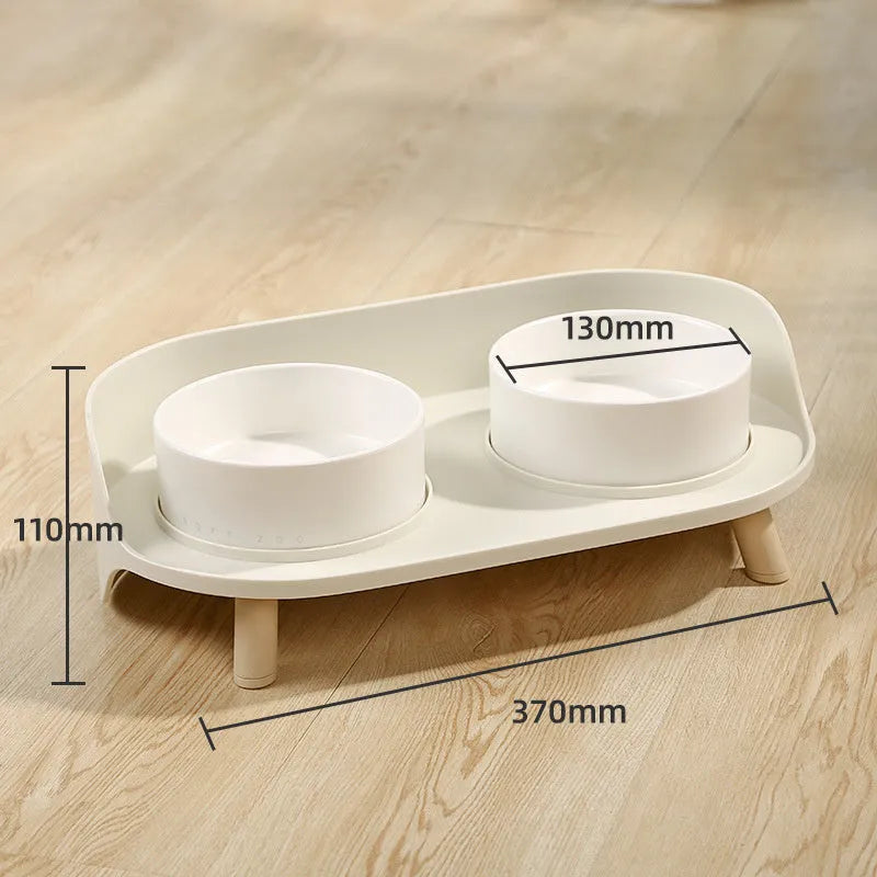 Green and white tilted pet feeder with two bowls for cats and dogs on a non-slip base.