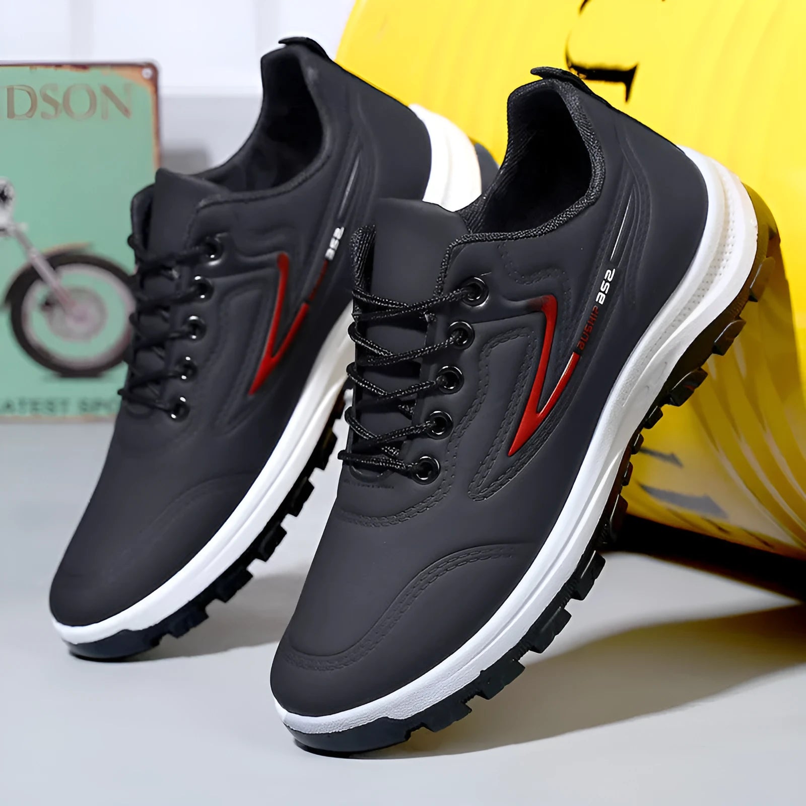 Men's black and grey waterproof PU casual shoes with a pointed toe and flat plastic sole on a white background.