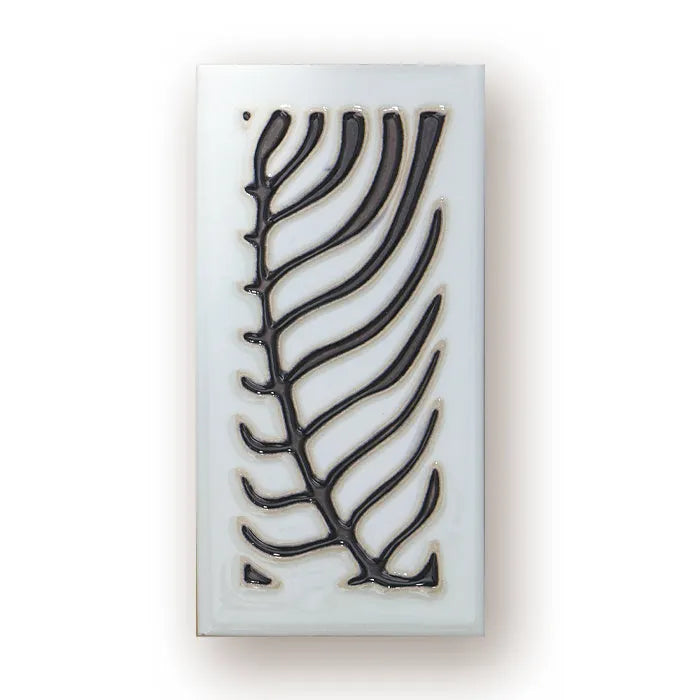 Handmade retro-style ceramic doorplate with fired enamel number, shown against a door.