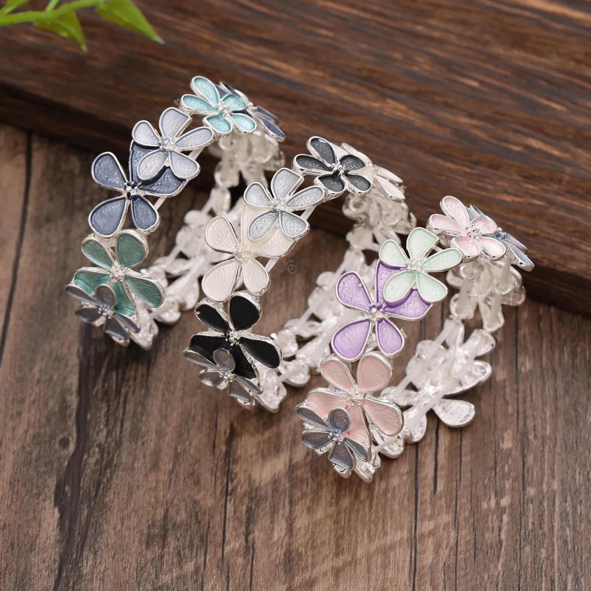 Zinc alloy flower elastic bracelet for women with dripping oil finish in blue, black, or colourful design.