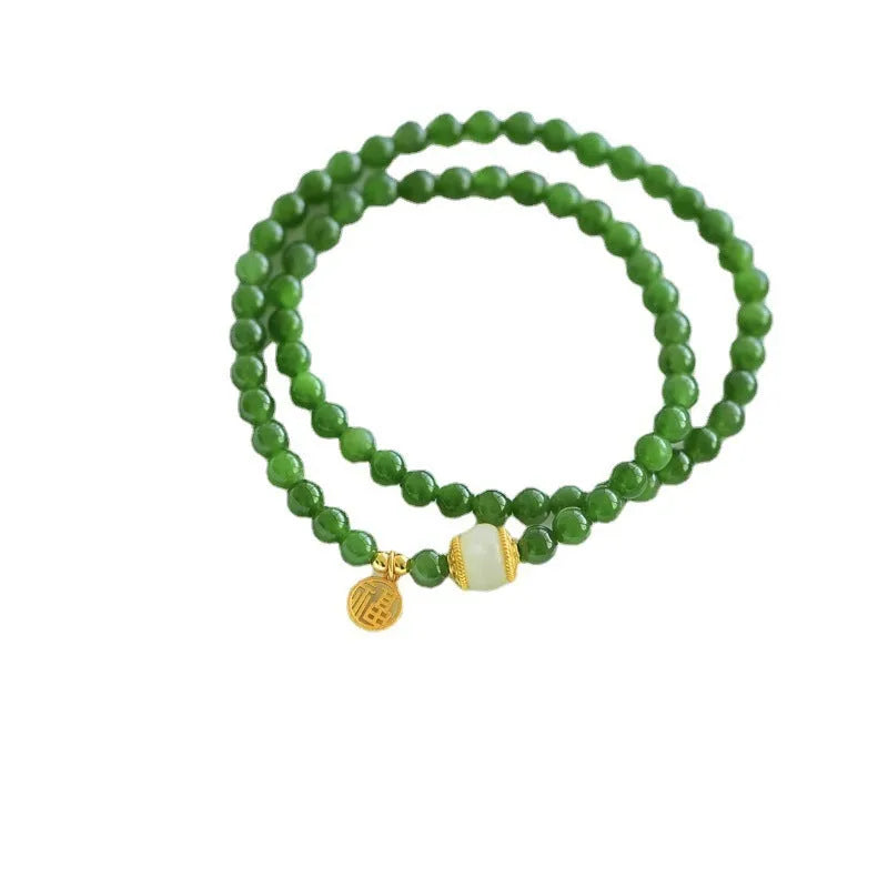 Women's double circle bracelet made from natural Hetian Jade, showing geometric shape and fu character detail.
