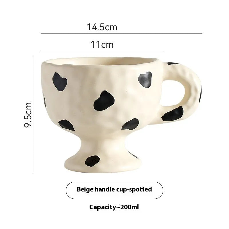 Irregularly shaped hand-pinched ceramic mug in a solid colour, shown on a plain background.