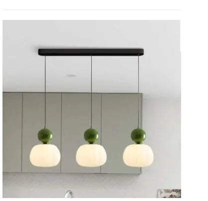 Creative alloy pumpkin chandelier light fixture for ceiling mounting in cream, red, green, chrome, or walnut finish.