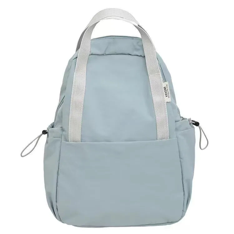 Solid colour nylon backpack with curved shoulder straps shown in five colour options