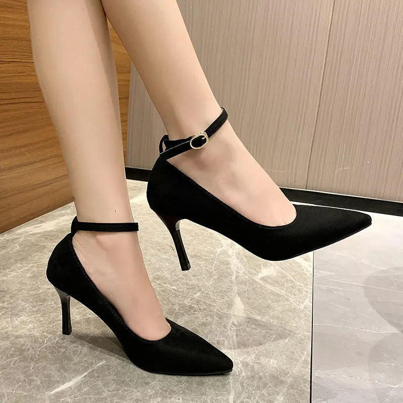 Women's black skull pattern stiletto heel pumps with buckle detail on rubber sole
