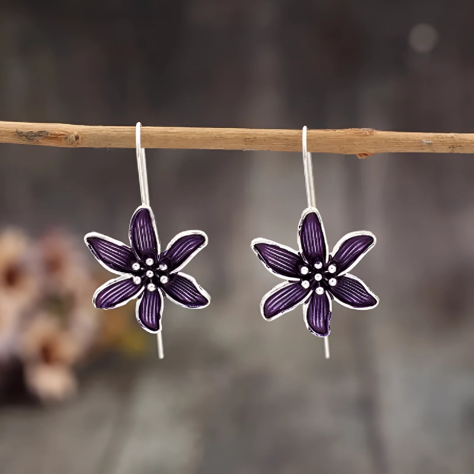 A pair of purple floral alloy earrings with a retro design on a white background.