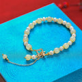 Gold-coloured Hetian jade bracelet with pearl pendant and Chinese style round beads