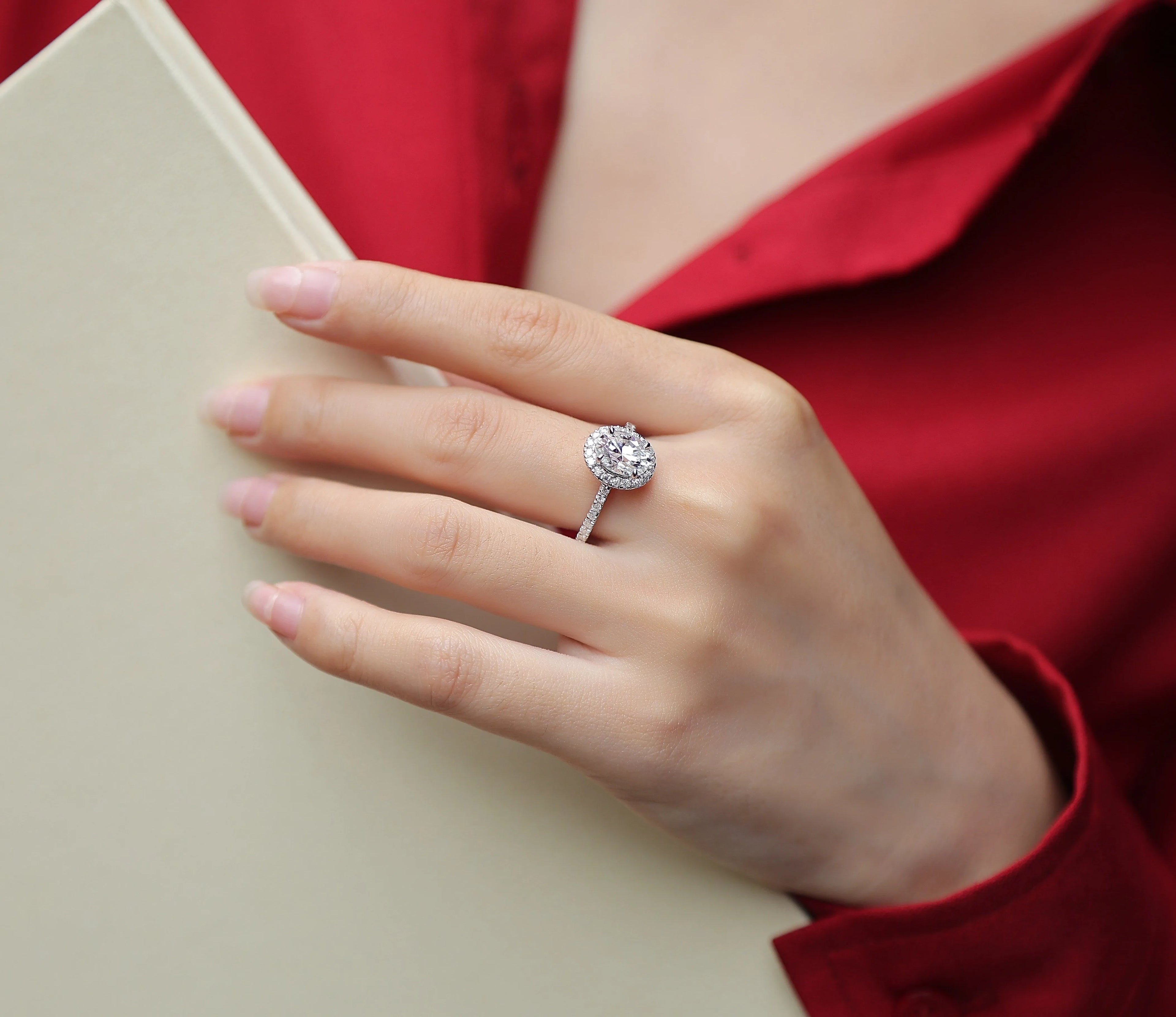 Audrey moissanite wedding ring set with egg-shaped 7x9mm stone in S925 silver platinum plating on white background