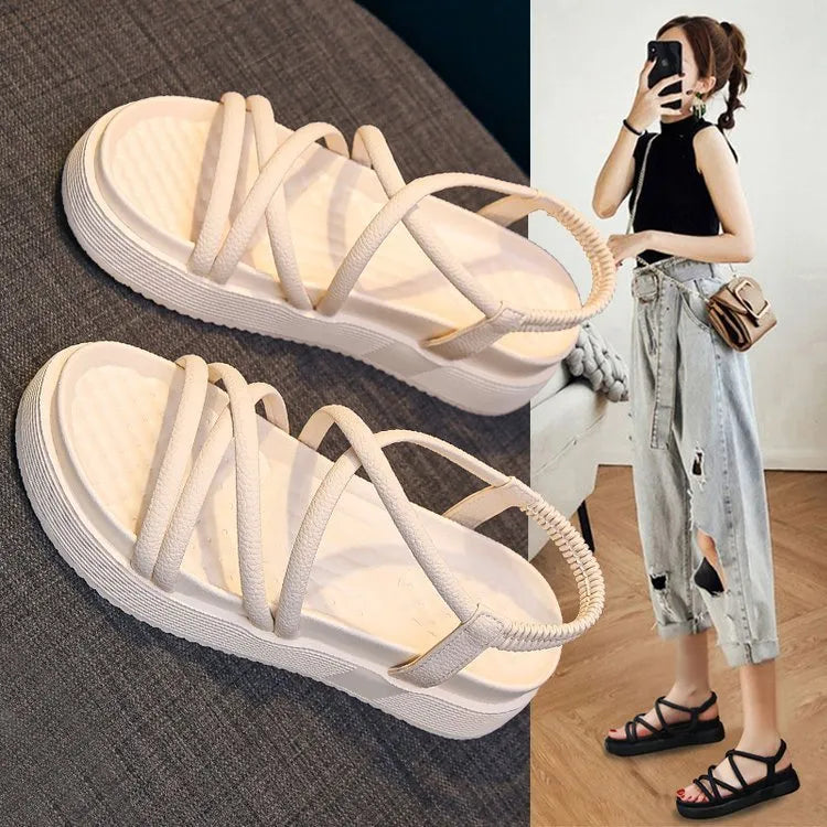 Women's black roman style platform sandals with straps on a white background.