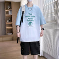 Boy wearing a dark blue youth T-shirt with a printed text pattern and drop-shoulder sleeves