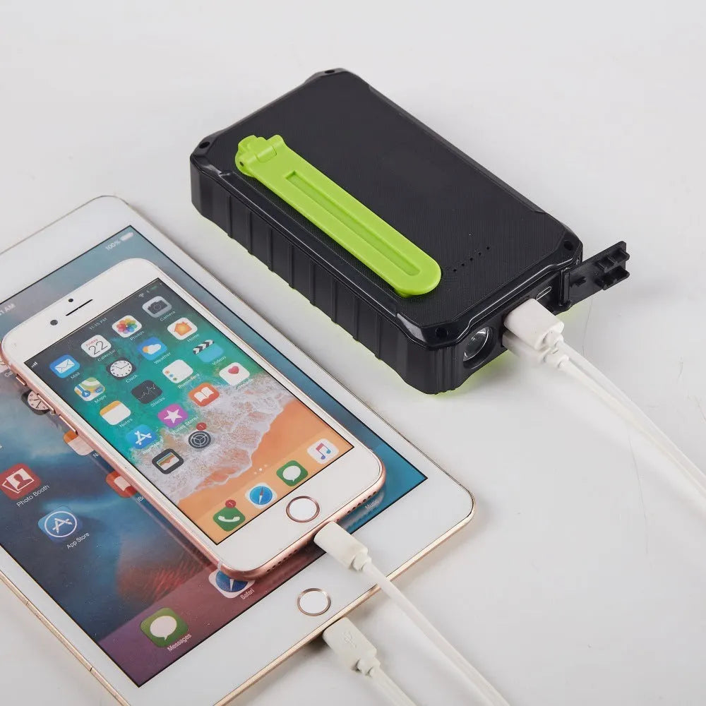 Orange and green hand solar mobile power bank with solar panel and hand crank showing dual USB ports