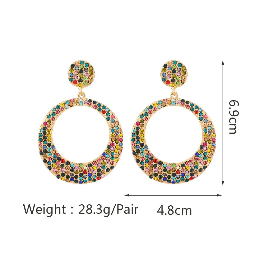 A pair of large round cartoon pendant earrings made from metal alloy, shown in a colour finish.