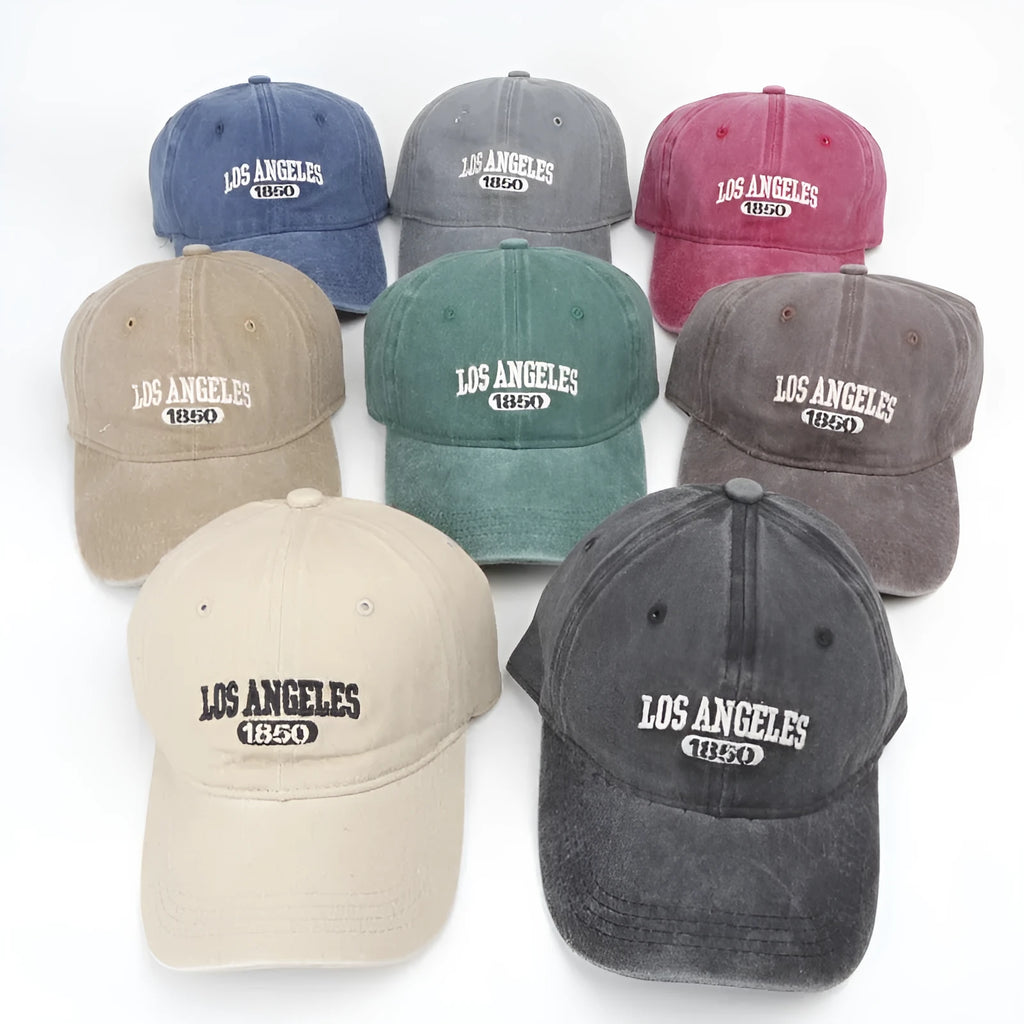 Retro beige peaked cap with embroidered letters, showing distressed fabric texture and adjustable strap.