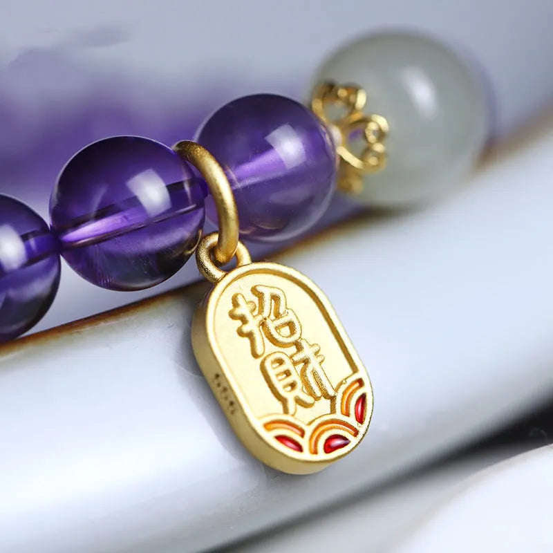 Close-up of a women's amethyst bracelet with 8mm geometric crystal beads on a wrist.