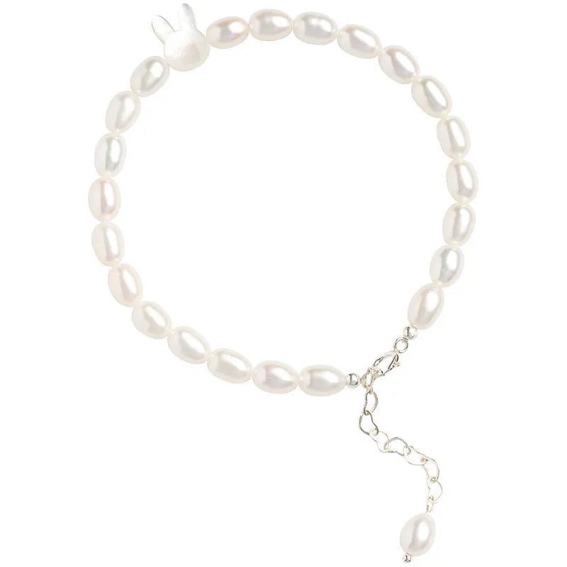 White shell bead bracelet with 925 silver rabbit charm on a black elastic string