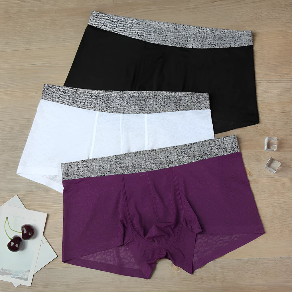 Men's seamless lace boxer briefs in a thin jacquard weave, shown in a solid colour with a low-waist design.