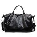 36-55L capacity hand-carry travel bag in black or silver with PU construction and polyester lining