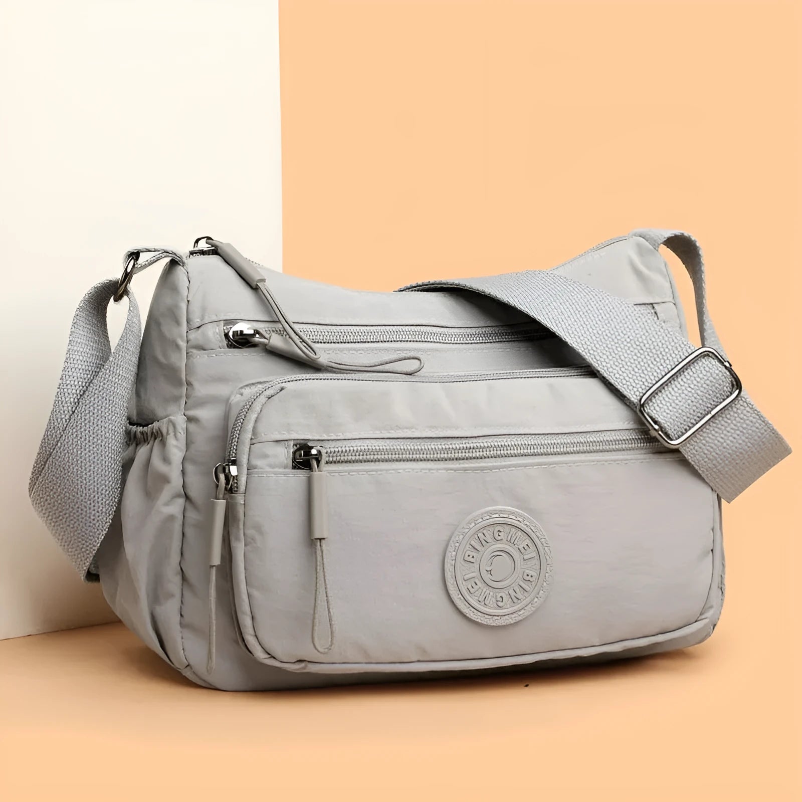 Soft water-repellent nylon crossbody bag showing three-dimensional pocket and adjustable shoulder strap