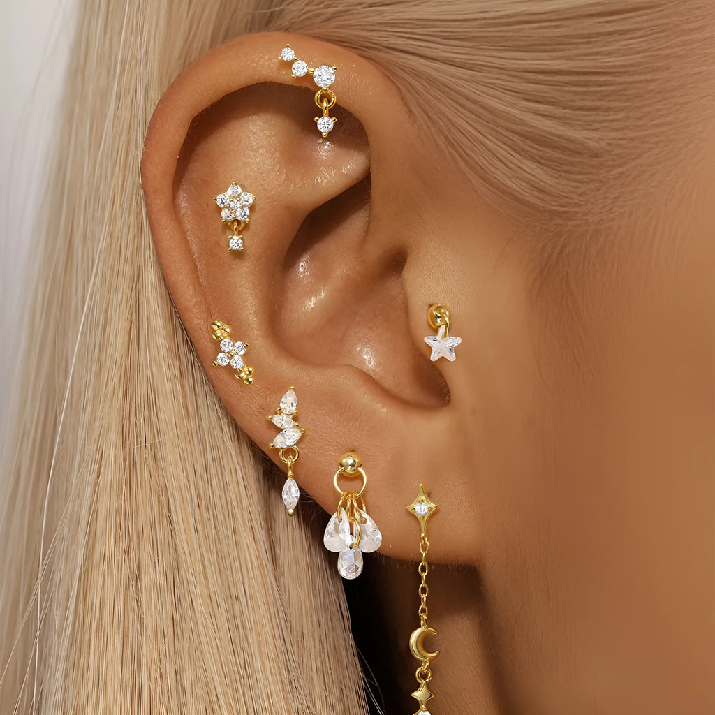 S925 sterling silver geometric star-shaped earrings with a moon and diamond detail in a gold tone.