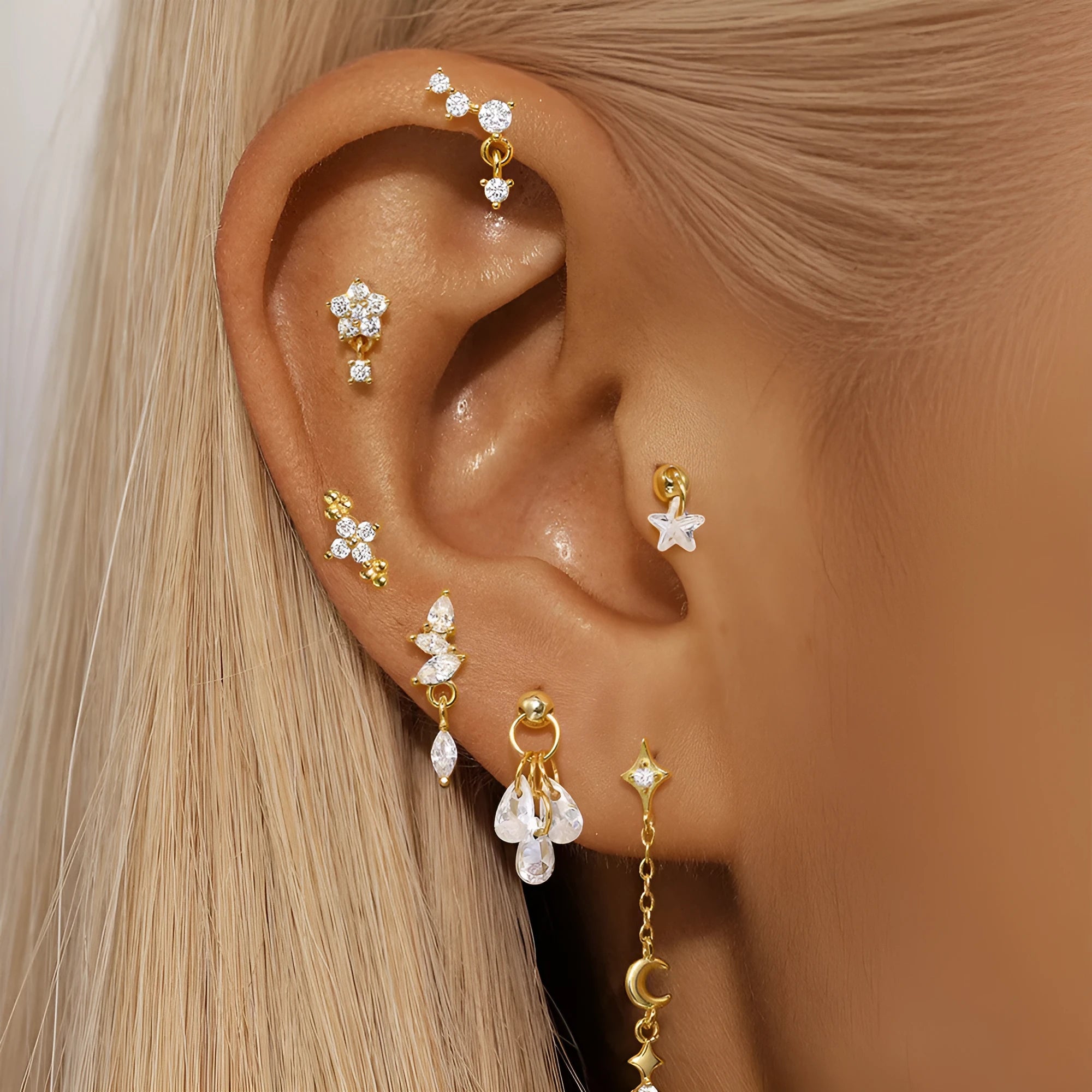 S925 sterling silver geometric star-shaped earrings with a moon and diamond detail in a gold tone.