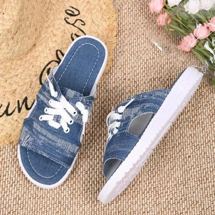 Blue Roman-style canvas slippers with cloth lining and rubber sole showing flat design