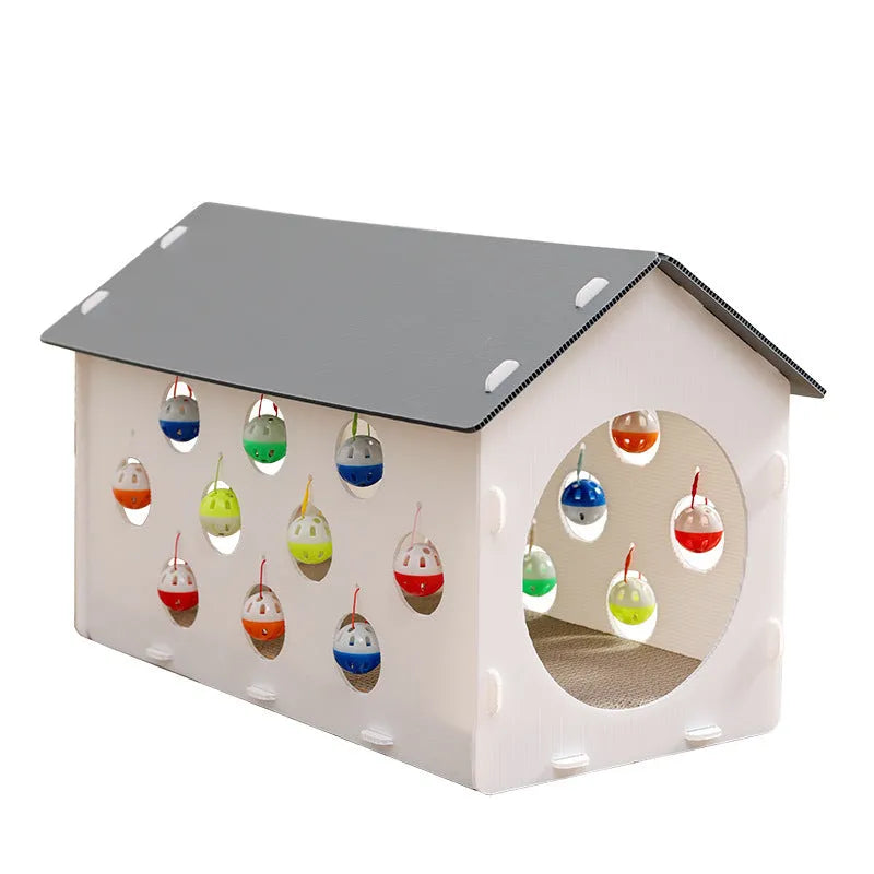 White plastic house-shaped cat scratch board with an integrated nest and a red bell ball toy inside.