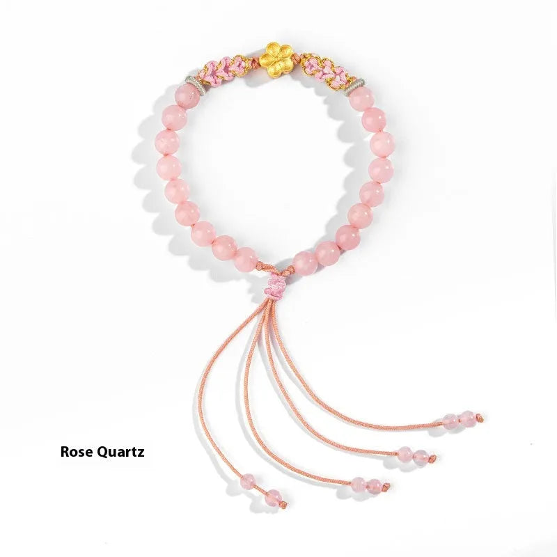 Hand-woven red rope bracelet with crystal centrepiece in Chinese peach blossom design