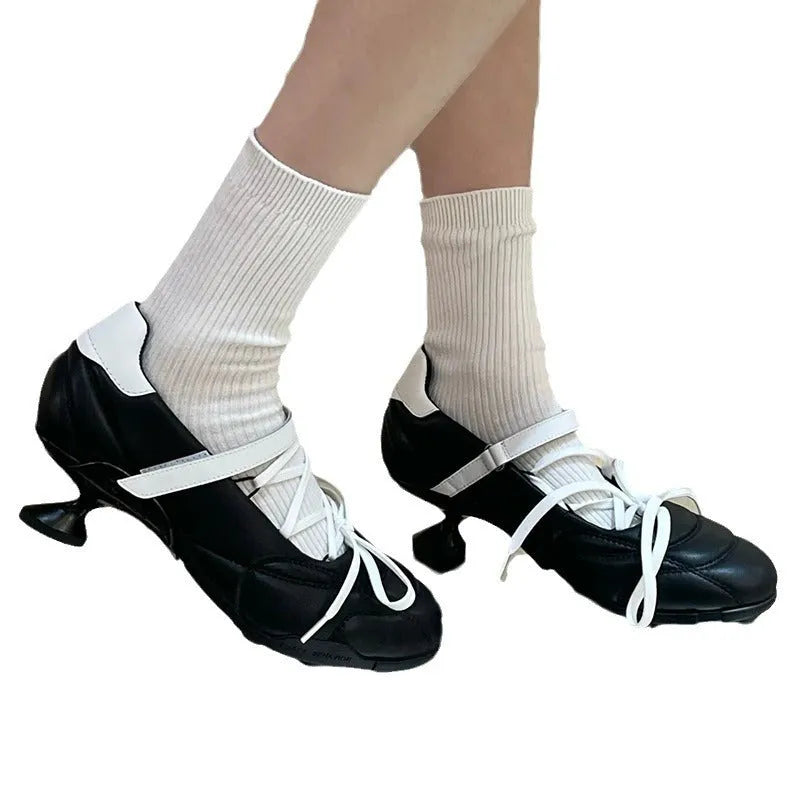 Women's silver low-top sports shoes with lace-up bow and a short stout heel on a viscose sole.