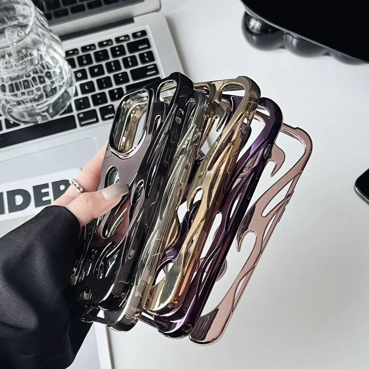 Electroplated hollow flame pattern soft TPU phone case for Apple iPhone, shown in silver on a dark background.
