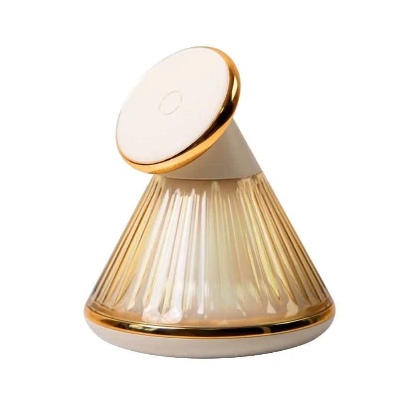 Champagne gold night table lamp with integrated magnetic wireless charging seat on its base.