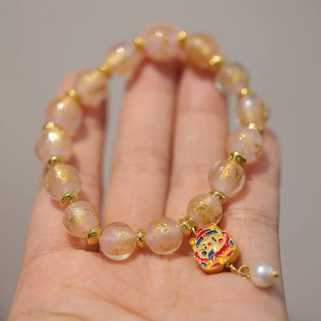 Handmade ethnic style coloured glaze bracelet with gold foil detailing and porcelain hanging gourd design
