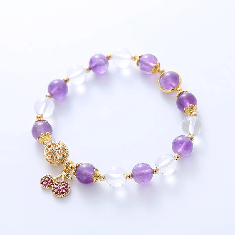 Close-up of a women's purple crystal bracelet with a micro-inlaid cherry flower design on an adjustable band.