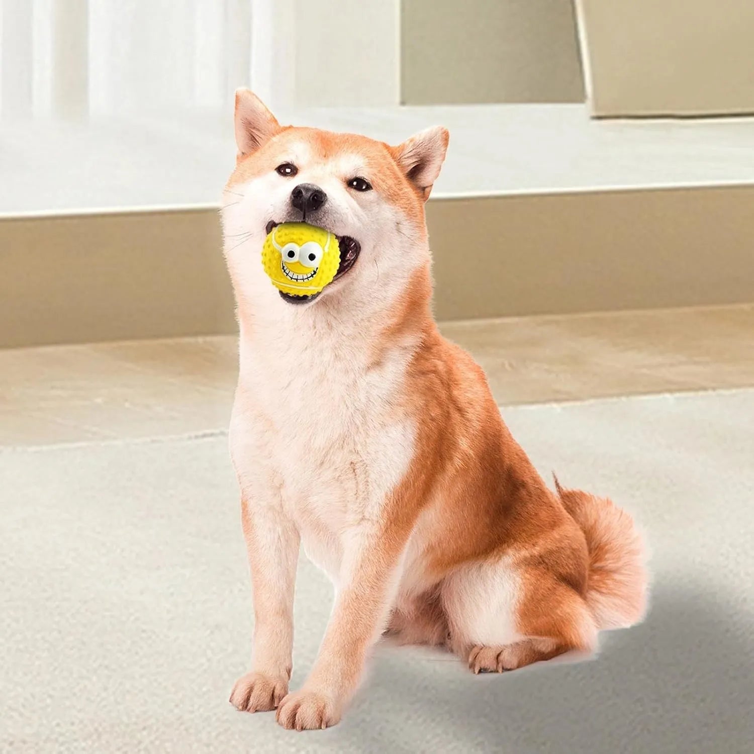 Green latex dog ball with a smiley face and squeaker for fetch games.