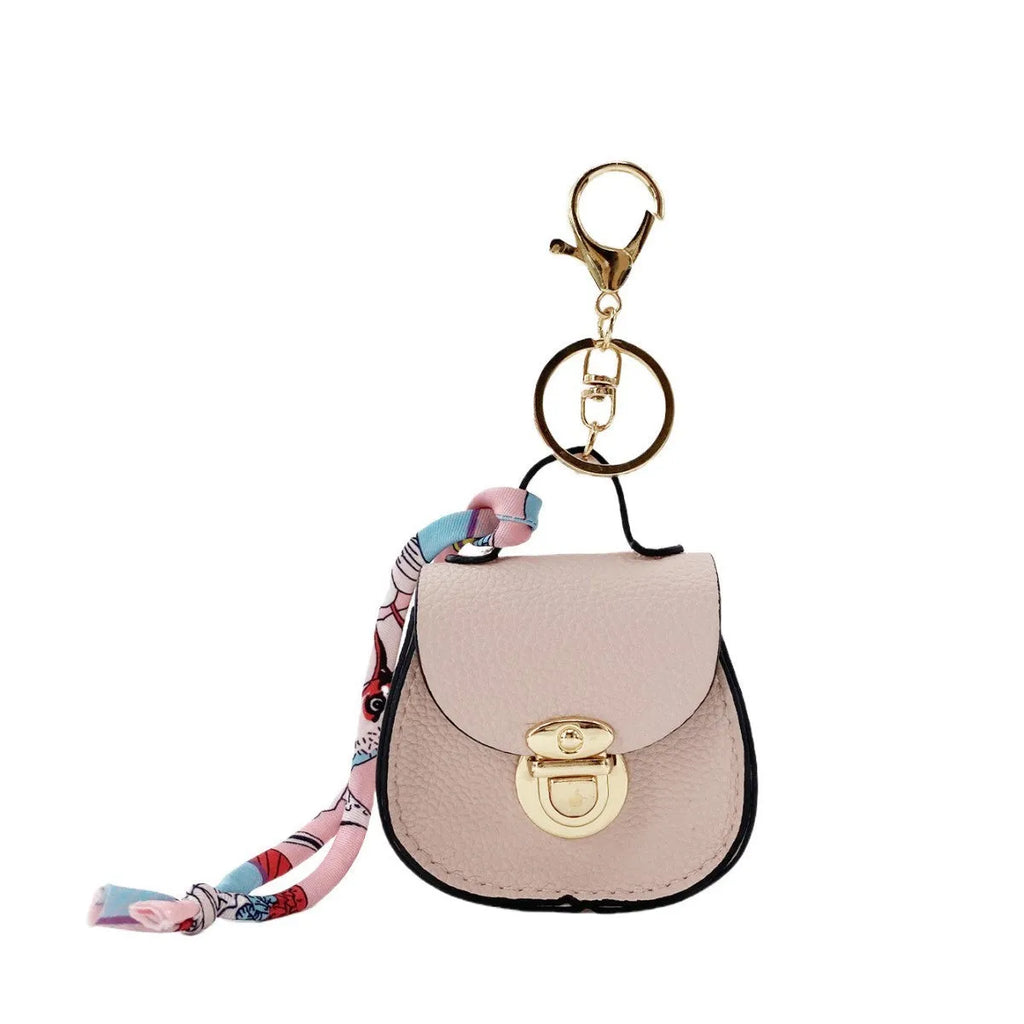 Small PVC coin purse with keychain in solid colour options including black, brown, orange, pink, red, and greige