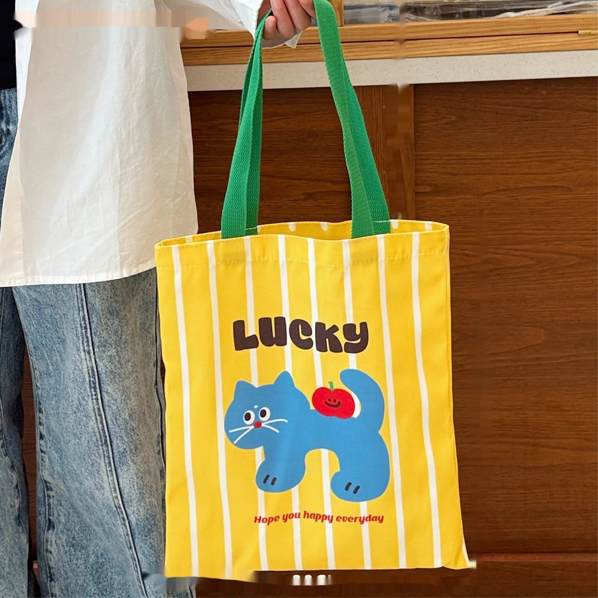 Cartoon print canvas handbag showing colourful design with 30x36x24cm dimensions