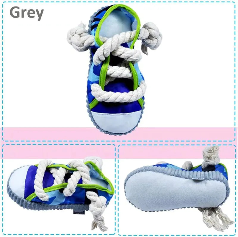 Grey and white dog toy slipper with black laces, blue sole, and a bell on the side