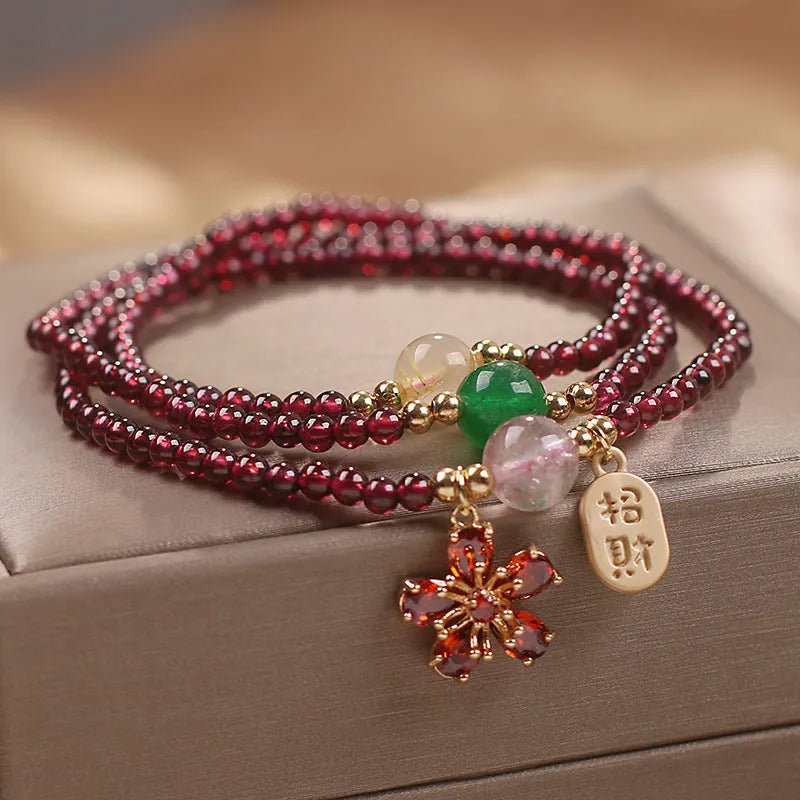 Women's crystal bracelet in pomegranate red cherry blossom colour with simple sequin detail on wrist