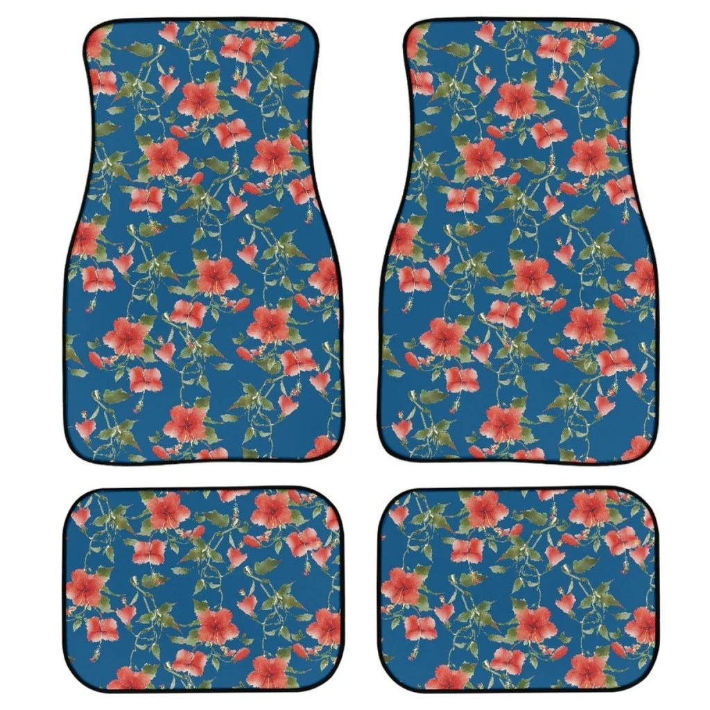 Set of four black printed rubber car floor mats with textured surface, shown on a car's footwell.