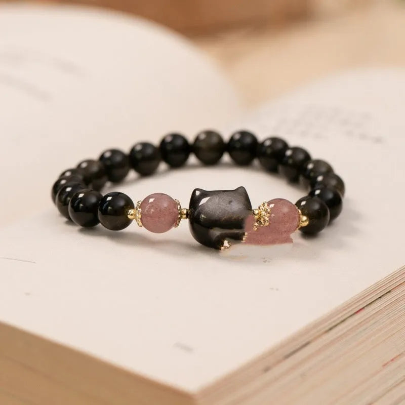 Black natural obsidian bead bracelet with a kitty charm on a stretch cord.