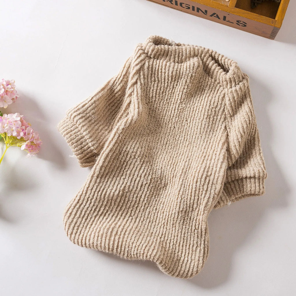 Brown cloth dog pullover sweater on a small white dog, showing casual style.