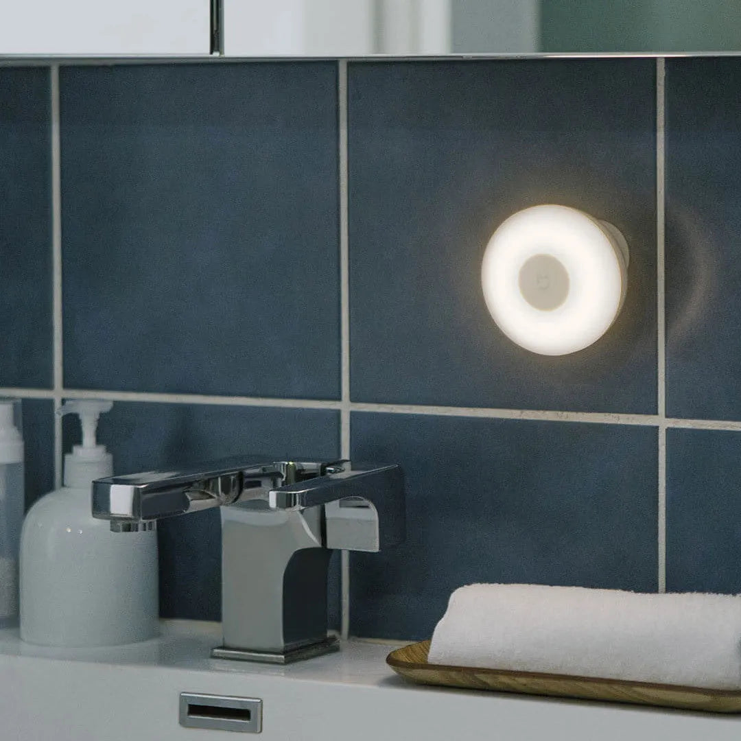 White modern bedside table lamp with human body induction and Bluetooth.
