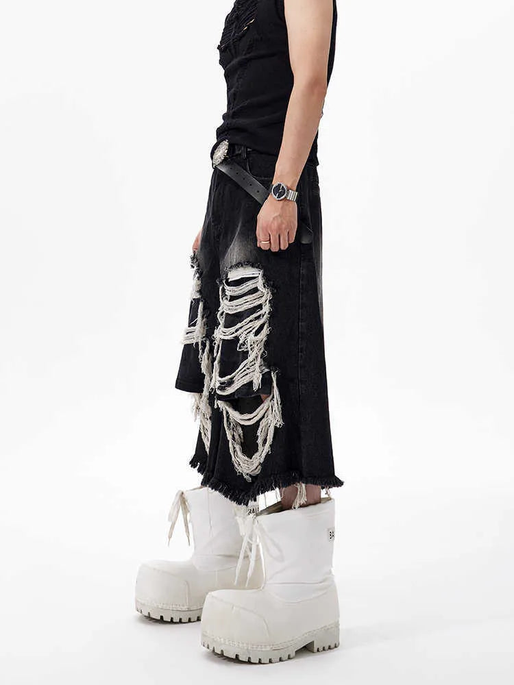 Black wide-leg cropped jeans with distressed patchwork detail and a mid-high waist.