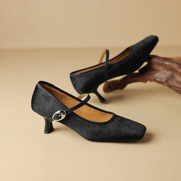 Black women's square toe stiletto ankle-strap heels with horse hair upper and buckle closure.