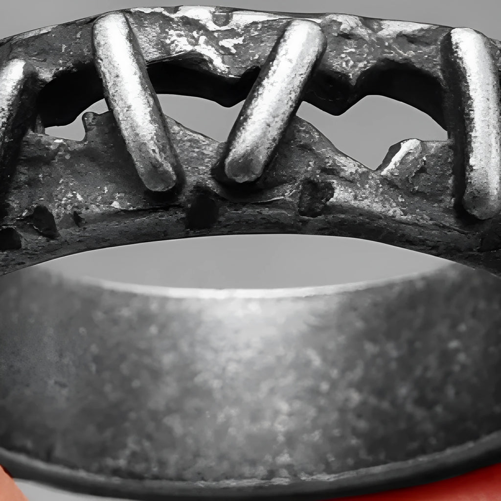 A dark stainless steel double ring with punk-inspired stitching detail on the band.