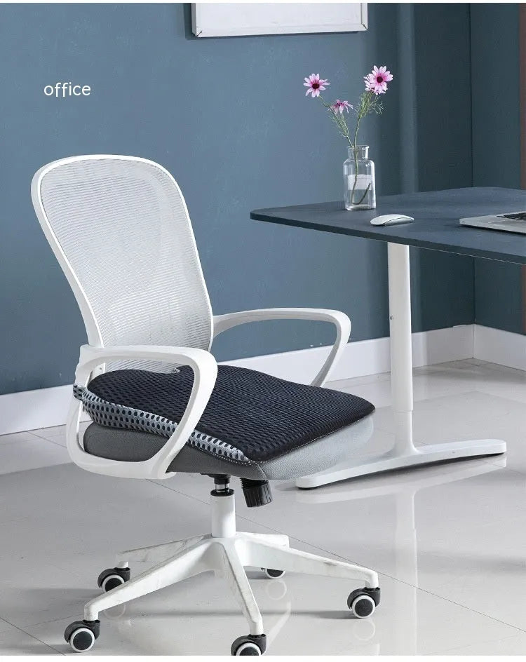A solid-colour memory foam seat cushion with an adjustable strap, shown in creamy white.