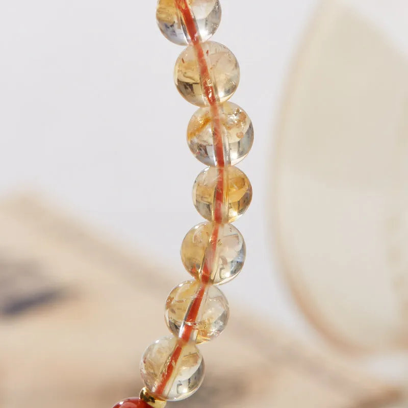 Hand-woven unisex bracelet with 6mm citrine beads in a five-sutra braid design.