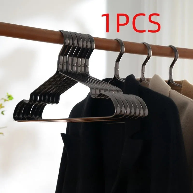 Elegant black non-slip clothes hanger for shirts, trousers and ties on a rail.