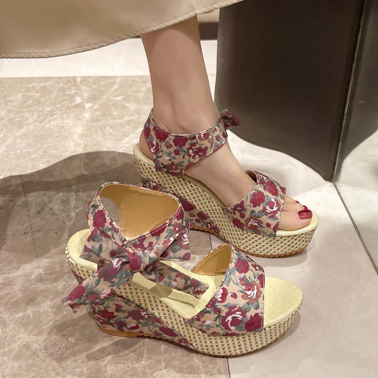 Women's floral wedge sandals with peep toe and ankle strap in pink, black, or blue.